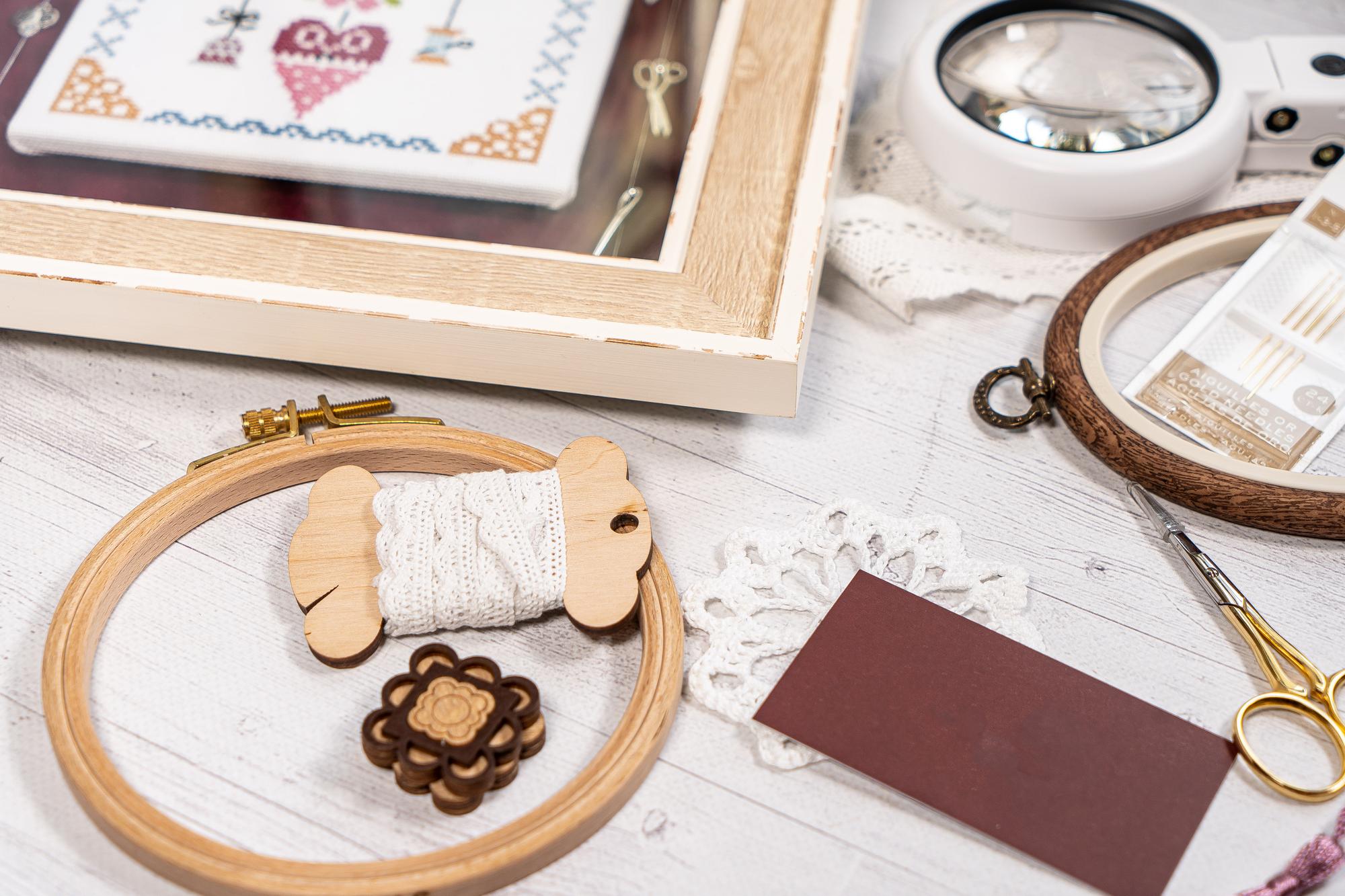Studio table with threads, hoops and sample cards
